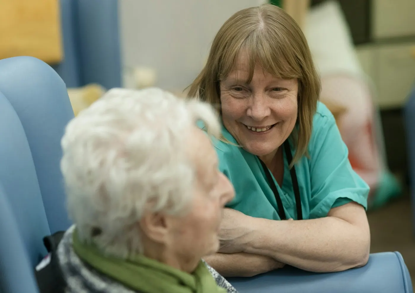 A caregiver smiling with an elderly client
