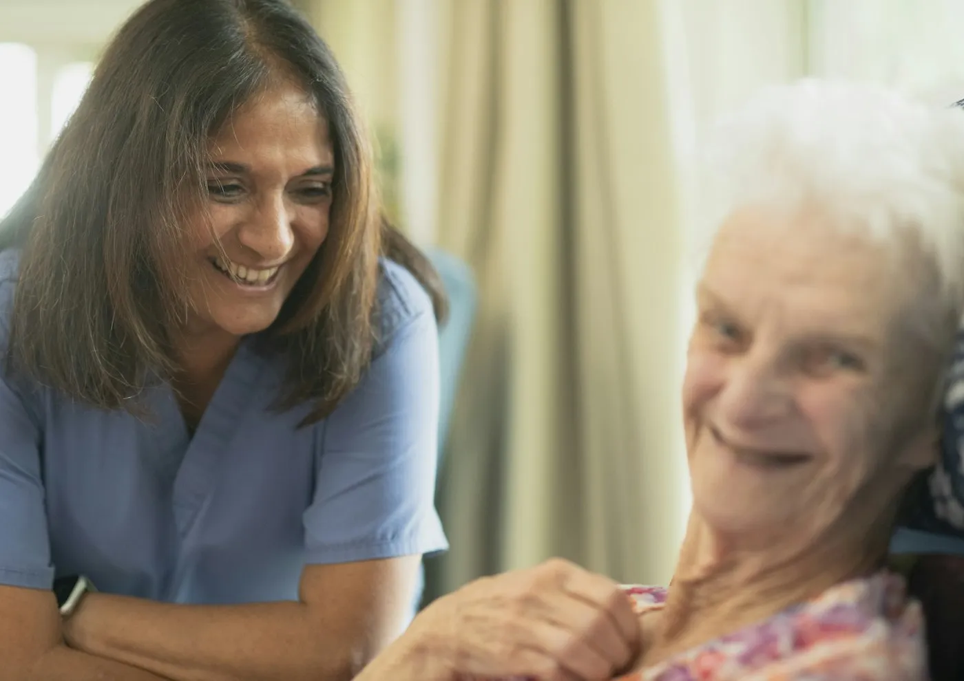 A caregiver sharing a warm moment with an elderly client