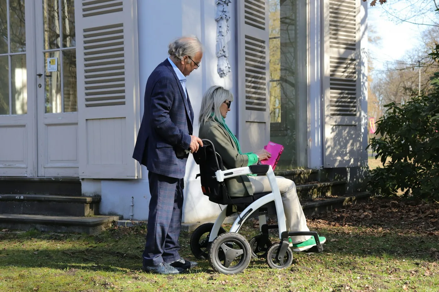 A couple walking together outside a care home